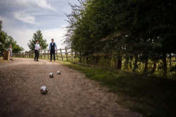 A group of men standing on a dirt path captured by a Dodford Manor wedding photographer.