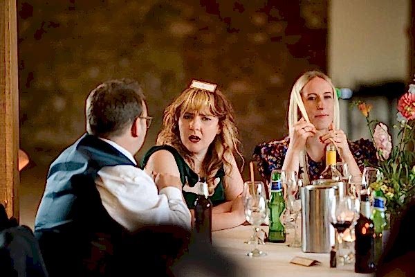 A group of people sitting around a table at a Dodford Manor wedding.