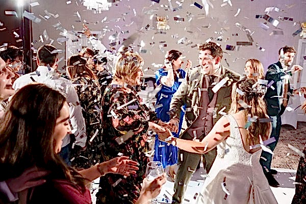 Dodford Manor Wedding Photographer captures the magical moments of confetti being thrown at a wedding reception.
