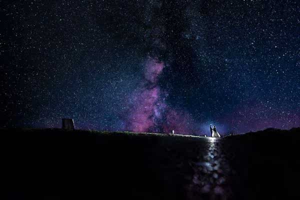 Dodford Manor Wedding Photographer captures a couple standing under a mesmerizing starry sky with the milky in the background.