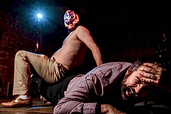 A man at Dodford Manor wedding is laying on the floor with a mask on his face.