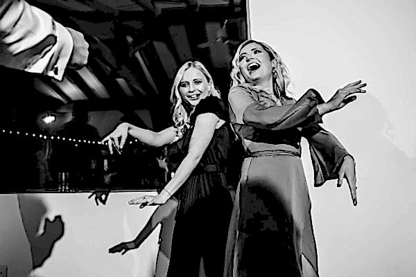 Dodford Manor Wedding Photographer captures two women dancing on the dance floor at a wedding.