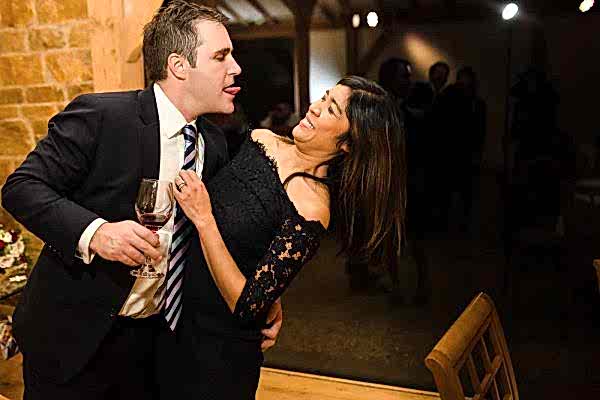 A man and woman sharing an intimate moment at a Dodford Manor wedding reception.
