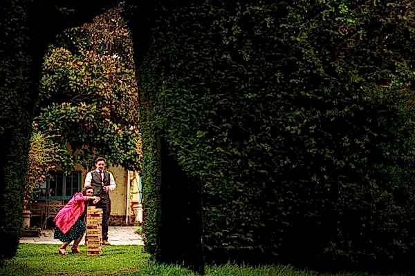 A man and a woman, the couple at Dodford Manor, standing in a picturesque garden.