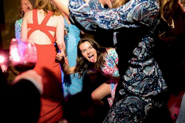 A group of people dancing at a Dodford Manor wedding party.