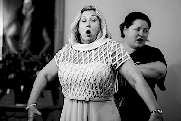 A Dodford Manor Wedding Photographer captures a woman standing next to a woman who is making a face.