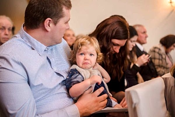 A woman holding a baby at Dodford Manor Wedding.