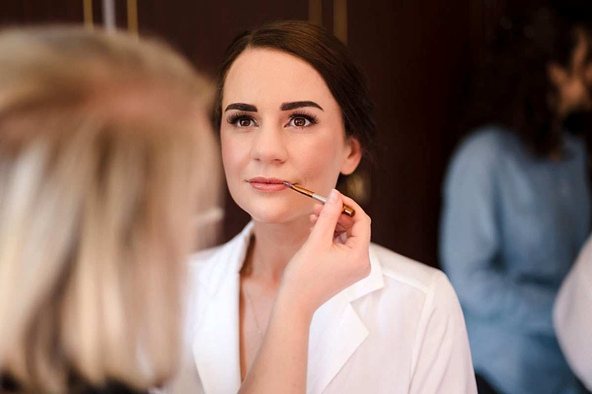 Bride having makeup applied